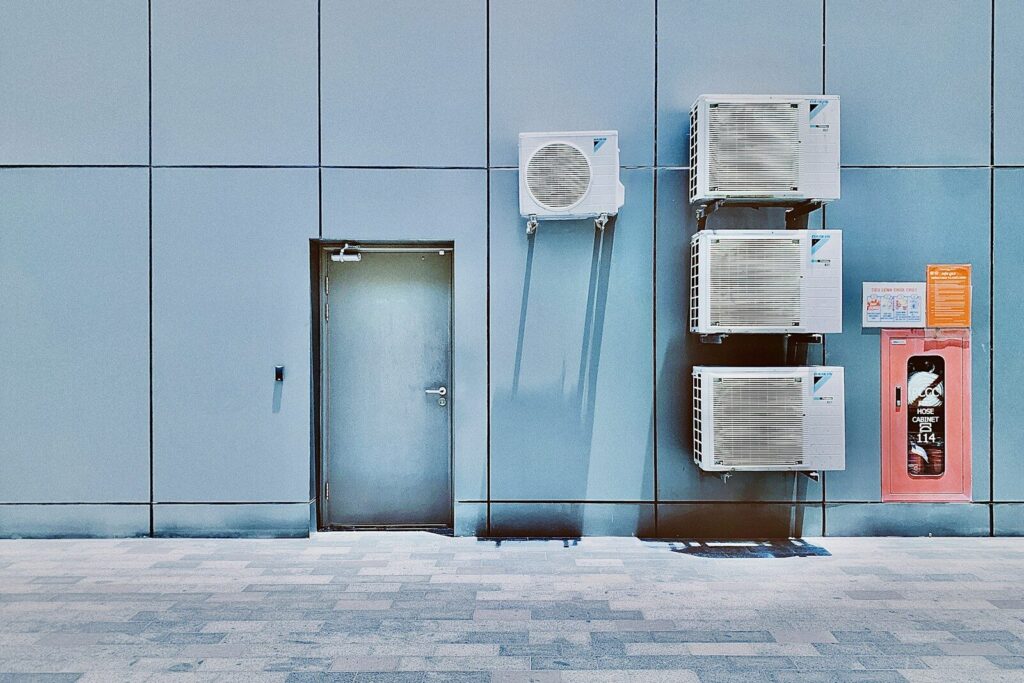 a couple of air conditioners sitting on the side of a building